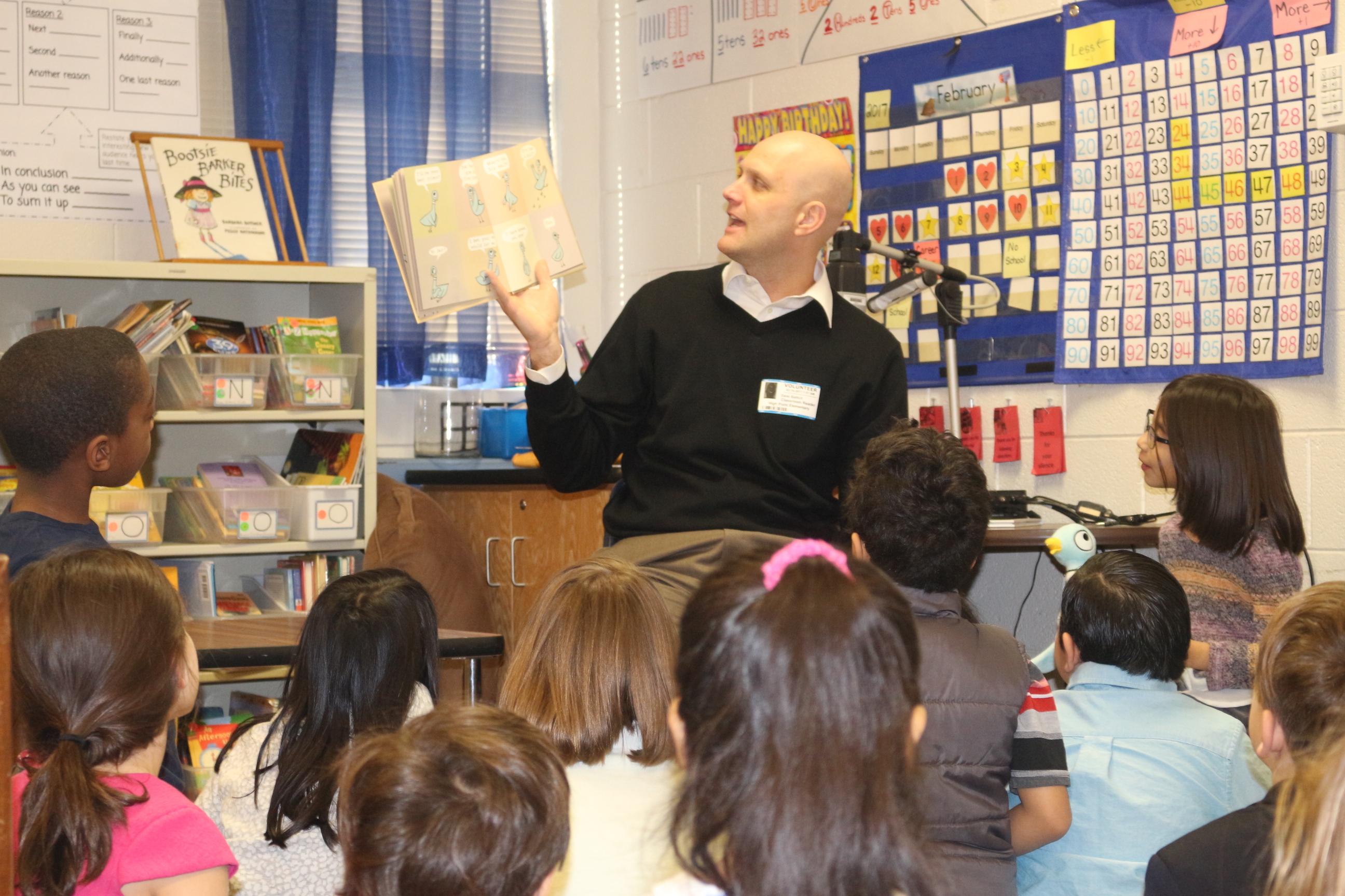 Guest reader reading to children in classroom