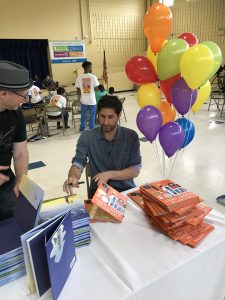 Author signing Books at Storybus Event